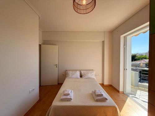 a bedroom with a large bed with towels on it at Sunny Home Private Jacuzzi Hydromassage, Fireplace, Acropolis & Lycabettus View, Underground Parking, 300m Metro Peristeri in Athens