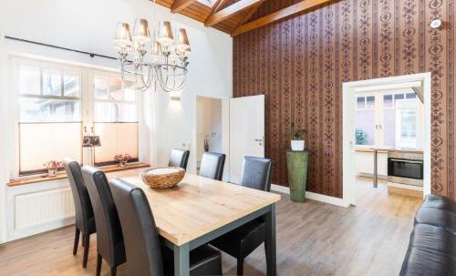 a kitchen and dining room with a table and chairs at Hygge 13 in Nortorf