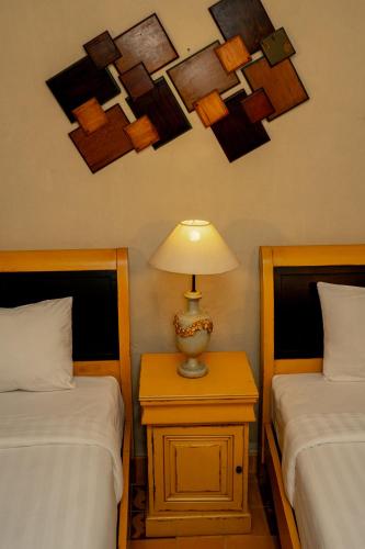 Postel nebo postele na pokoji v ubytování Kayu Arum Resort