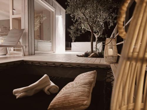 a swimming pool with a pillow on a patio at Vila Amara - Resort Vita in Drage