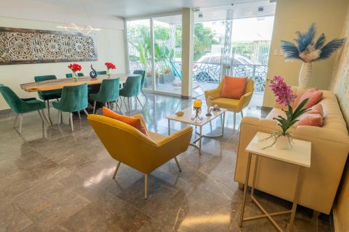 a living room with a couch and chairs and a table at Hotel Bahía Azul Manga Cartagena in Cartagena de Indias