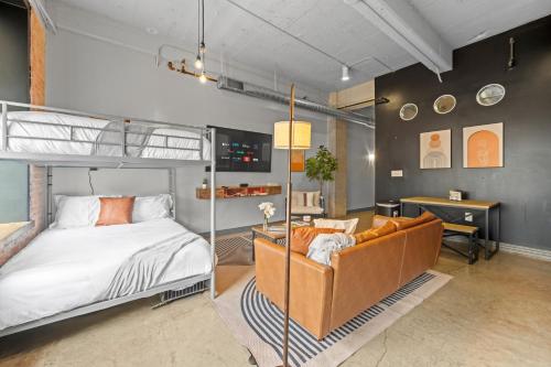 a bedroom with a bunk bed and a couch at Stunning Downtown Apartment with Pool, Laundry, Parking in Dallas