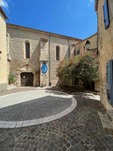 a cobblestone street in front of a stone building at Village House With Valley View In Tourrettes in Tourrettes