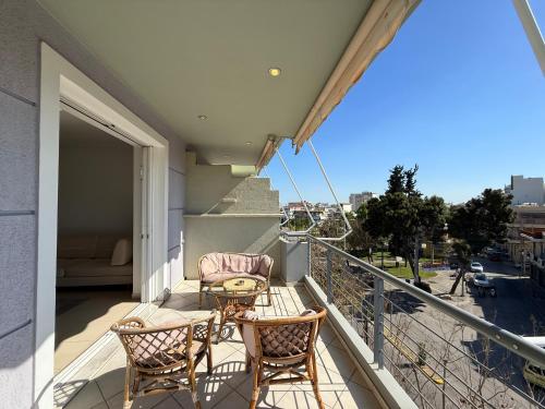 a balcony with two chairs and a table at Sunny Home Private Jacuzzi Hydromassage, Fireplace, Acropolis & Lycabettus View, Underground Parking, 300m Metro Peristeri in Athens