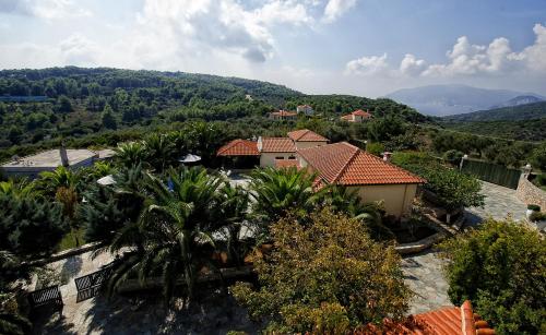 an aerial view of a house with trees and mountains at Vatellis Villas in Patitiri