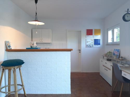 a kitchen with a counter and a stool in it at Apartment ZenPunta in Pučišća