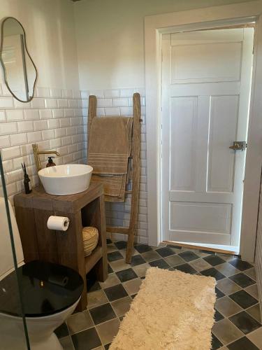 a bathroom with a sink and a toilet at Traditional Scanian Farm In The Fields Of Österlen in Gärsnäs
