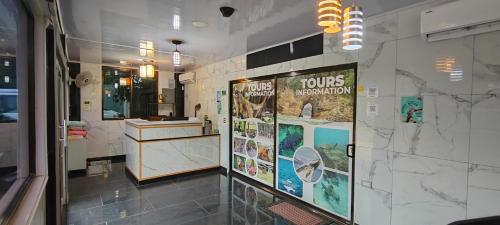 a bathroom with posters on the wall at Ballena Rey Hotel in Uvita