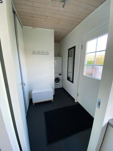a hallway with a washer and dryer in a house at Billund Sol Center House in Billund