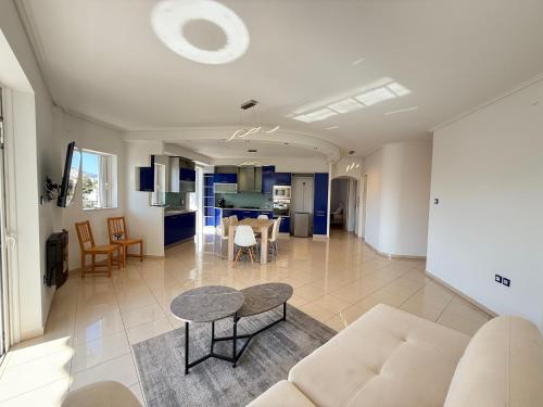a living room with a couch and a table at Sunny Home Private Jacuzzi Hydromassage, Fireplace, Acropolis & Lycabettus View, Underground Parking, 300m Metro Peristeri in Athens