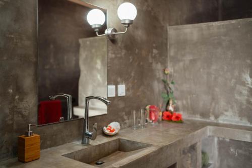 a bathroom with a sink and a mirror at South Pacific Memories in Port Vila