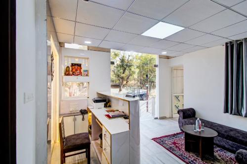 an office with a desk and chairs in a room at Hotel O Connect in Jaipur