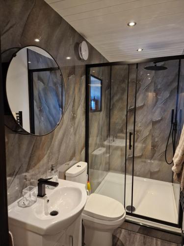 a bathroom with a sink and a toilet and a tub at The Stables by Blake View Holidays, comprising The Nest, The Drey, The Burrow and the Den, 3 miles from Ennerdale in Rowrah