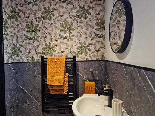 a bathroom with a sink and a mirror at The Stables by Blake View Holidays, comprising The Nest, The Drey, The Burrow and the Den, 3 miles from Ennerdale in Rowrah