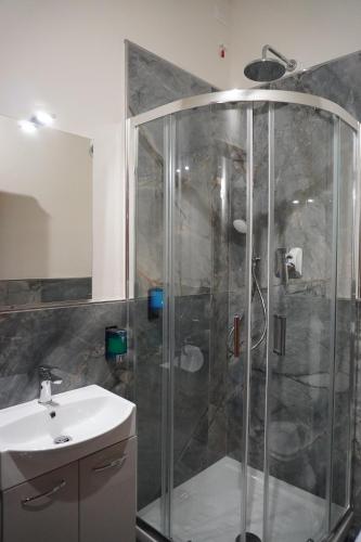 a bathroom with a shower and a sink at Hello Francesca Guesthouse in Florence