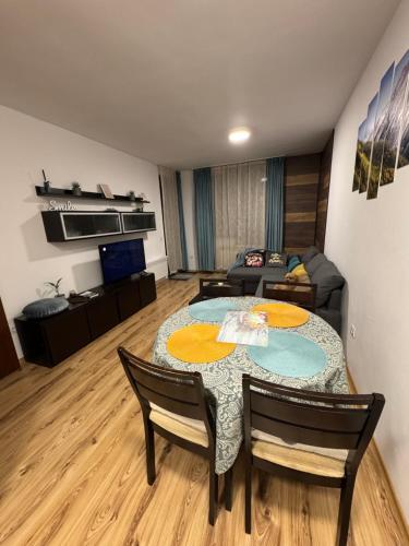 a living room with a table and a couch at Borovets Gardens MVS Apart D42 in Borovets