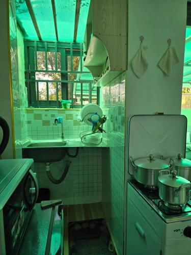 a kitchen with two pots and a sink and a stove at Neim Homes in Meru