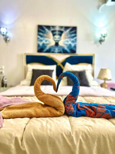 two towels in the shape of a heart on a bed at Luxury Panorama pyramids & jacuzzi in Cairo