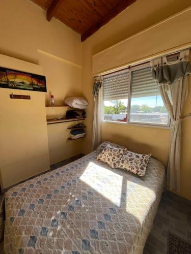 a small bedroom with a bed and a window at El patio apart in Esquina