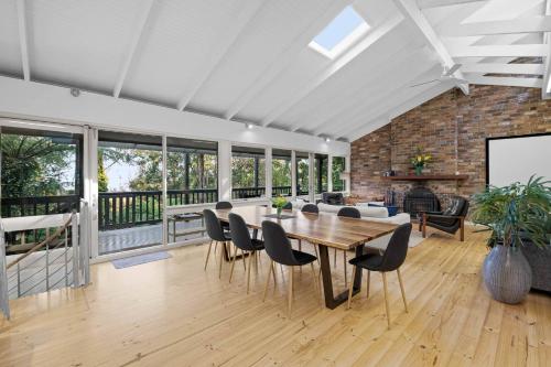 a dining room with a table and chairs at Forest Hideaway - with Sauna in Menzies Creek