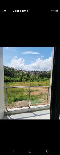 a window of a train with a view of a field at Cozy Luxe 2 Bedroom 2 Bath Apartment with Balcony BBB NATION OASIS KIGALI in Kigali