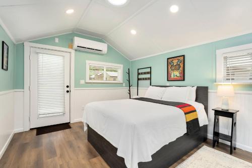 a bedroom with a white bed and blue walls at Riverside Colorado in Bellvue
