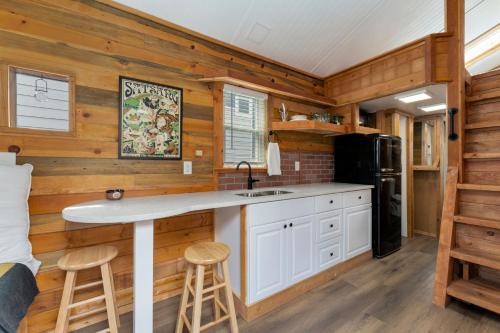 a kitchen with wooden walls and a counter with a sink at Riverside Colorado in Bellvue
