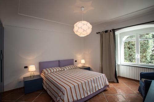 a bedroom with a bed and a large window at Villa Mascia in Anacapri