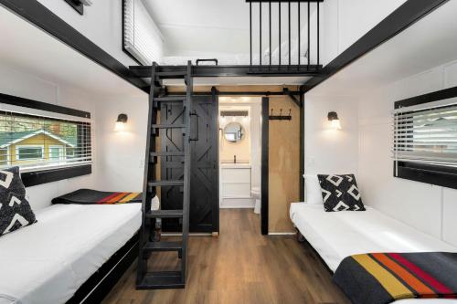 a room with two bunk beds and a staircase at Riverside Colorado in Bellvue