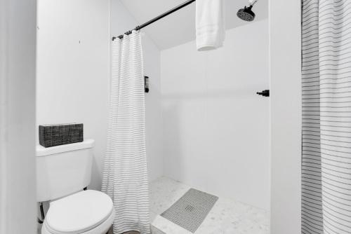 a white bathroom with a toilet and a shower at Riverside Colorado in Bellvue
