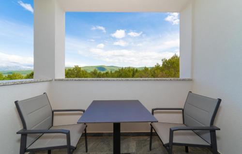a table and chairs in a room with a window at Awesome Apartment In Pridraga With Wifi in Pridraga