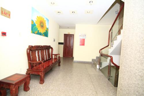 a hallway with a chair and a stair case at Truong Giang Hotel in Ho Chi Minh City