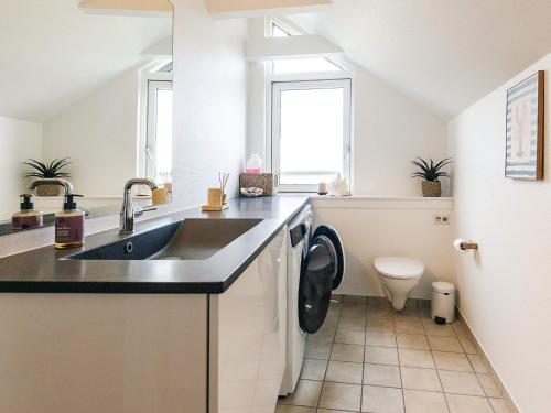 a kitchen with a sink and a toilet at 5 star holiday home in Køge in Køge