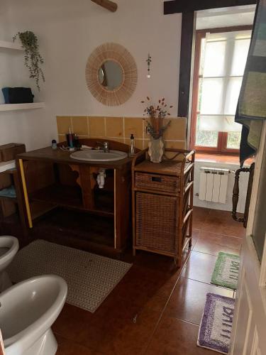 a bathroom with a sink and a mirror at Basoan etxea in Sopuerta