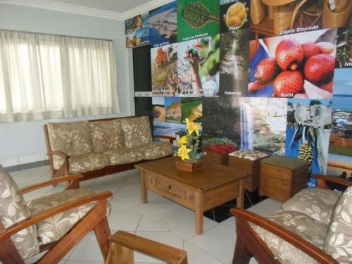 a living room with a couch and a table at Via Norte Hotel in Gurupi