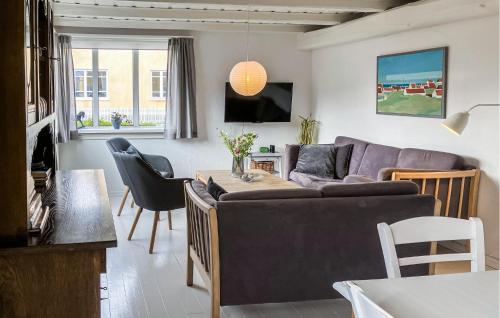 a living room with a couch and a table at 4 Bedroom Beautiful Home In Skagen in Skagen