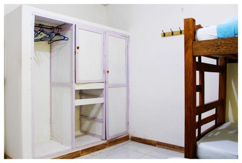 a white cabinet in a room with a bunk bed at Casa Bambudas in Rincón