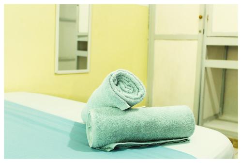 a stack of towels sitting on a bed at Casa Bambudas in Rincón