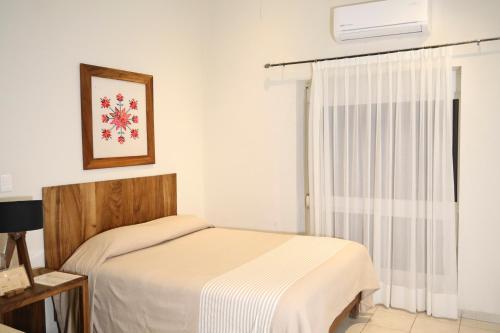Postel nebo postele na pokoji v ubytování Hotel Casa Ortiz