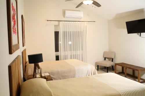 Postel nebo postele na pokoji v ubytování Hotel Casa Ortiz