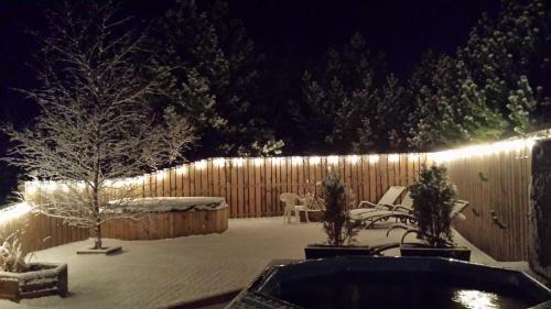 a backyard with a fence and a snow covered yard at Gesthus Selfoss in Selfoss