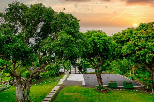 a view of a park with trees and a building at THE OASIS RESORT CondoBimbo 1-Big Room, Balcony, kitchen, Pool, Wifi, Videoke in San Fernando