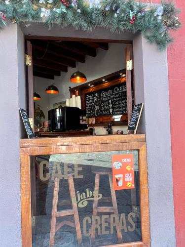 a sign in the window of a coffee shop at Hotel Casa Oratorio "Adults Only" in San Miguel de Allende