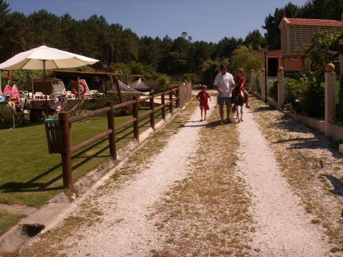a man and two children walking down a dirt road at Cabañas de Lires in Lires