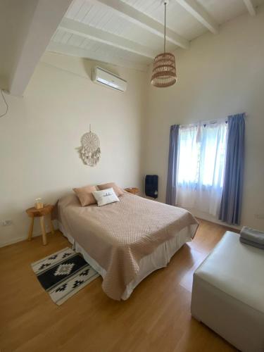 a bedroom with a bed and a couch at Buen Descanso 2 in San Pedro