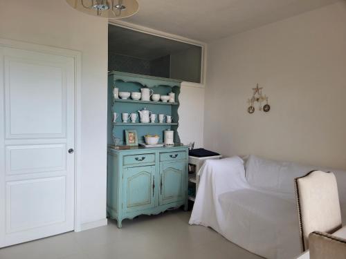 a bedroom with a bed and a blue cabinet at Casa Tiemme Vista Mare in Costa Paradiso