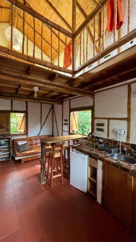 a large kitchen with a table and a counter at Casa Entera Finca Cometa in San Agustín