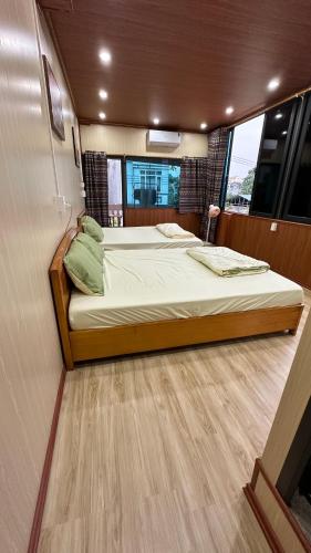 a bedroom with two beds on a boat at cat homestay in Hoàng Ngà