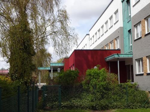 a red building in front of two buildings at Trend Hotel in Banzkow