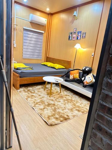 a room with two bunk beds and a table at Cat homestay in Hoàng Ngà